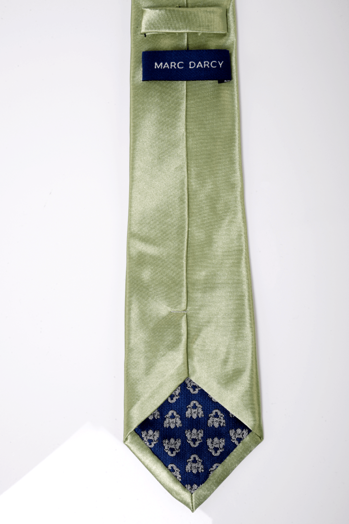 The ST - Satin Tie and Pocket Square Set In Green by Accessory features a light green satin tie with a blue and white patterned tip, MARC DARCY label on the back, and is perfect for pairing with its matching pocket square. Displayed on a white background.