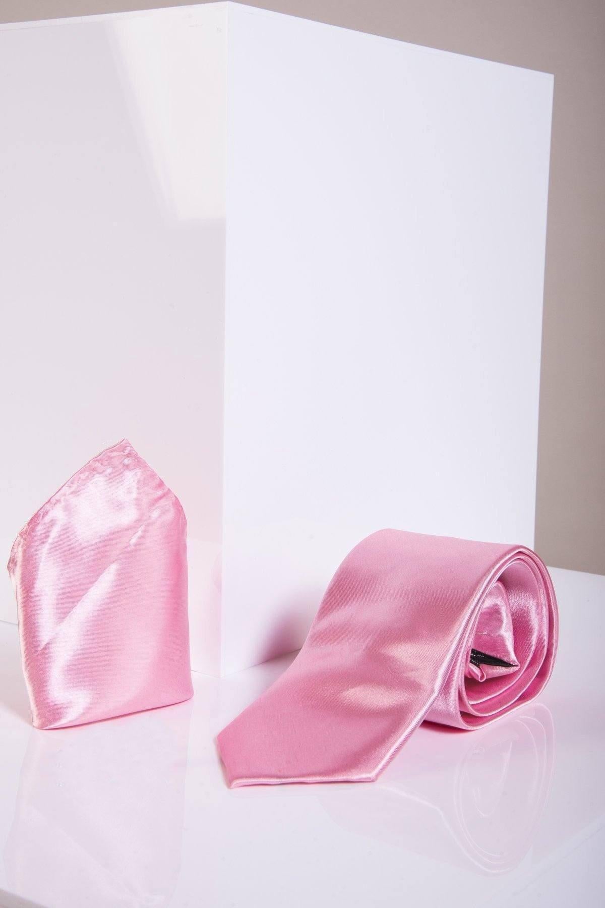The Accessory STANLEY Satin Tie and Pocket Square Set in pink is shown on a white surface with a white block behind it.