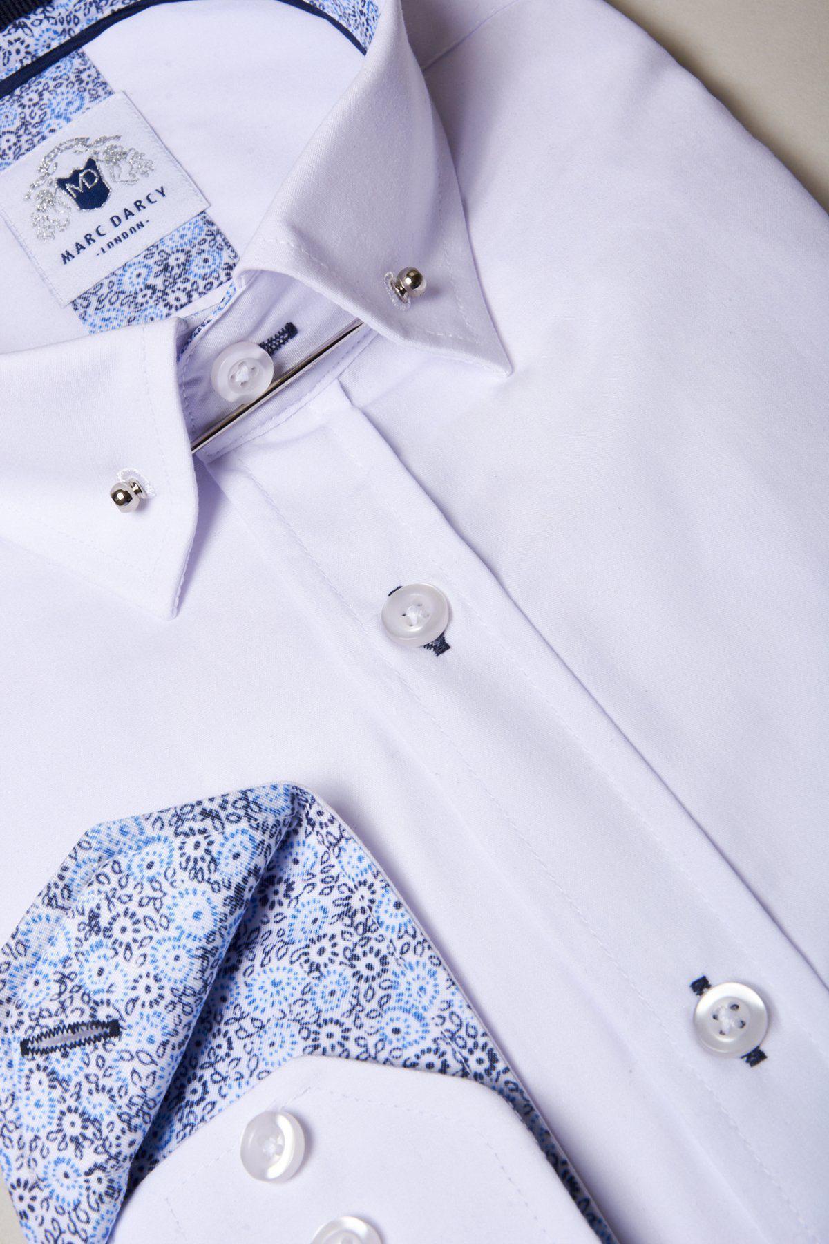 The SUTTON White Shirt With Collar Bar by marcdarcy features a pinned collar, patterned blue and white inner accents, white buttons, and brand label at the neck—a crisp cotton-blend shirt ideal for formal events.