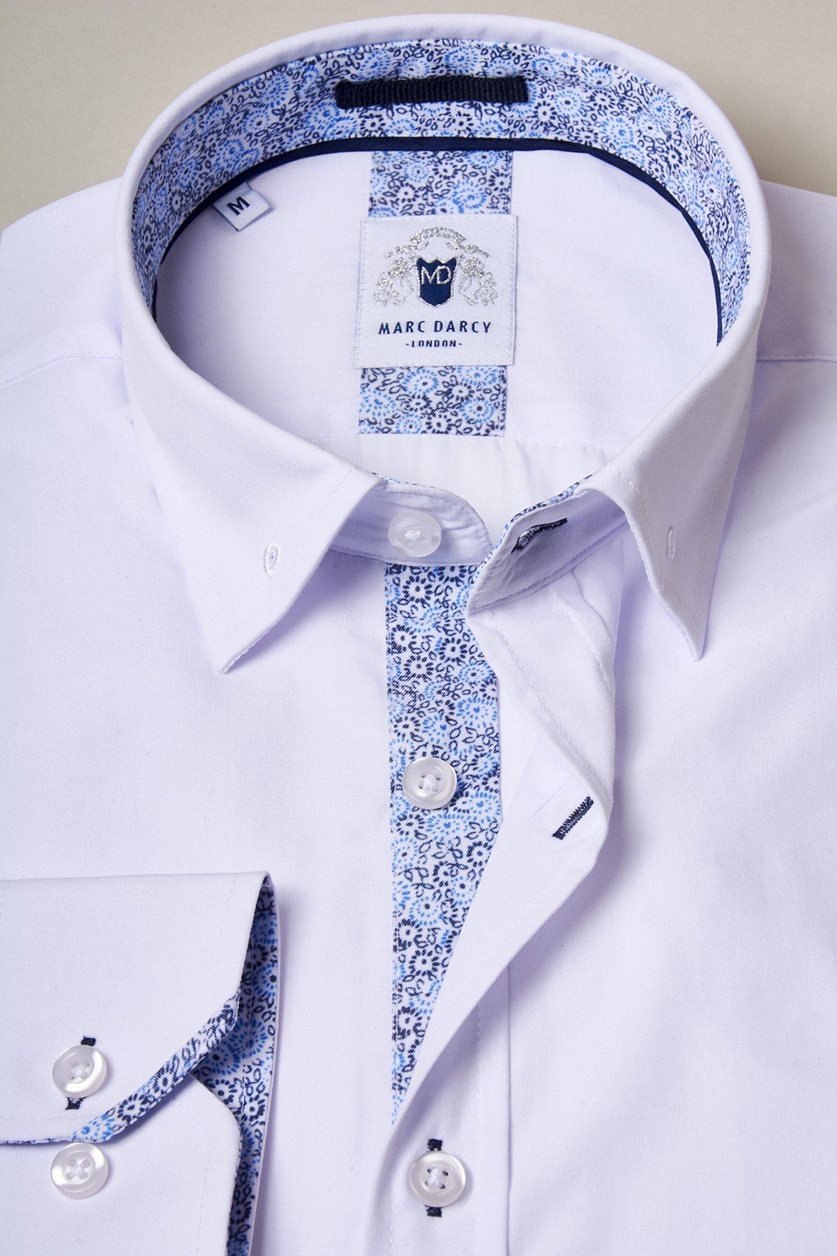The SUTTON white shirt with collar bar by marcdarcy features a blue floral trim on the collar and placket. Made from a soft cotton-blend, this medium shirt is ideal for formal occasions.