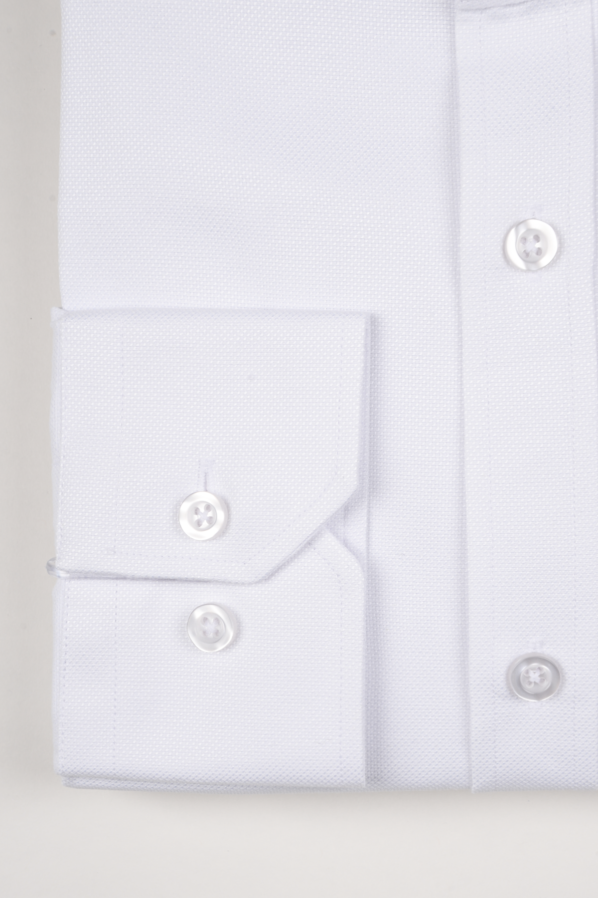 Close-up of the Marc Darcy THOMAS white grandad collar shirt in premium cotton blend, featuring front buttons and a double-button cuff. Ideal for achieving a smart-casual look.