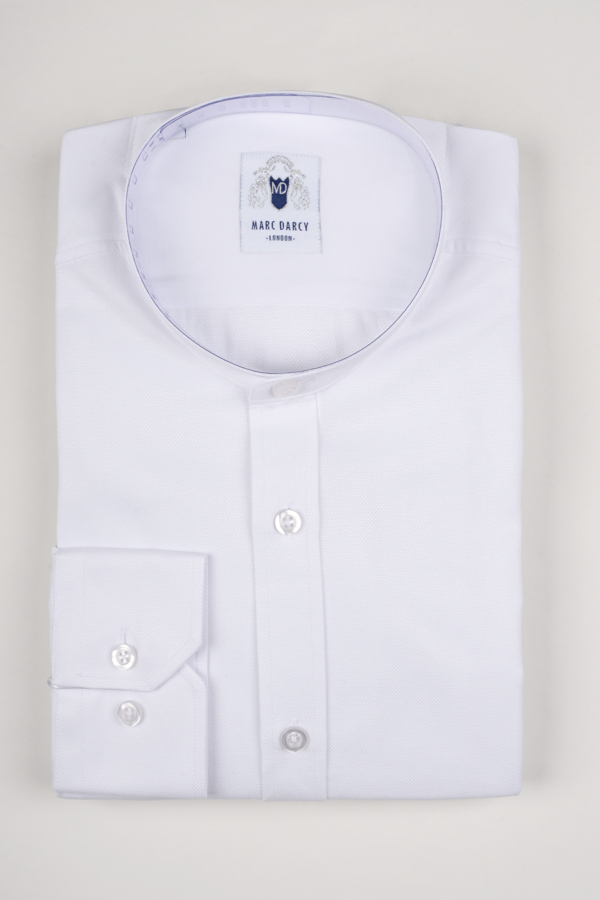 The THOMAS white grandad collar shirt by Marc Darcy features buttoned cuffs, visible buttons, and a high-quality cotton blend. Displayed against a light background, its ideal for smart-casual occasions. Label: Marc Darcy.