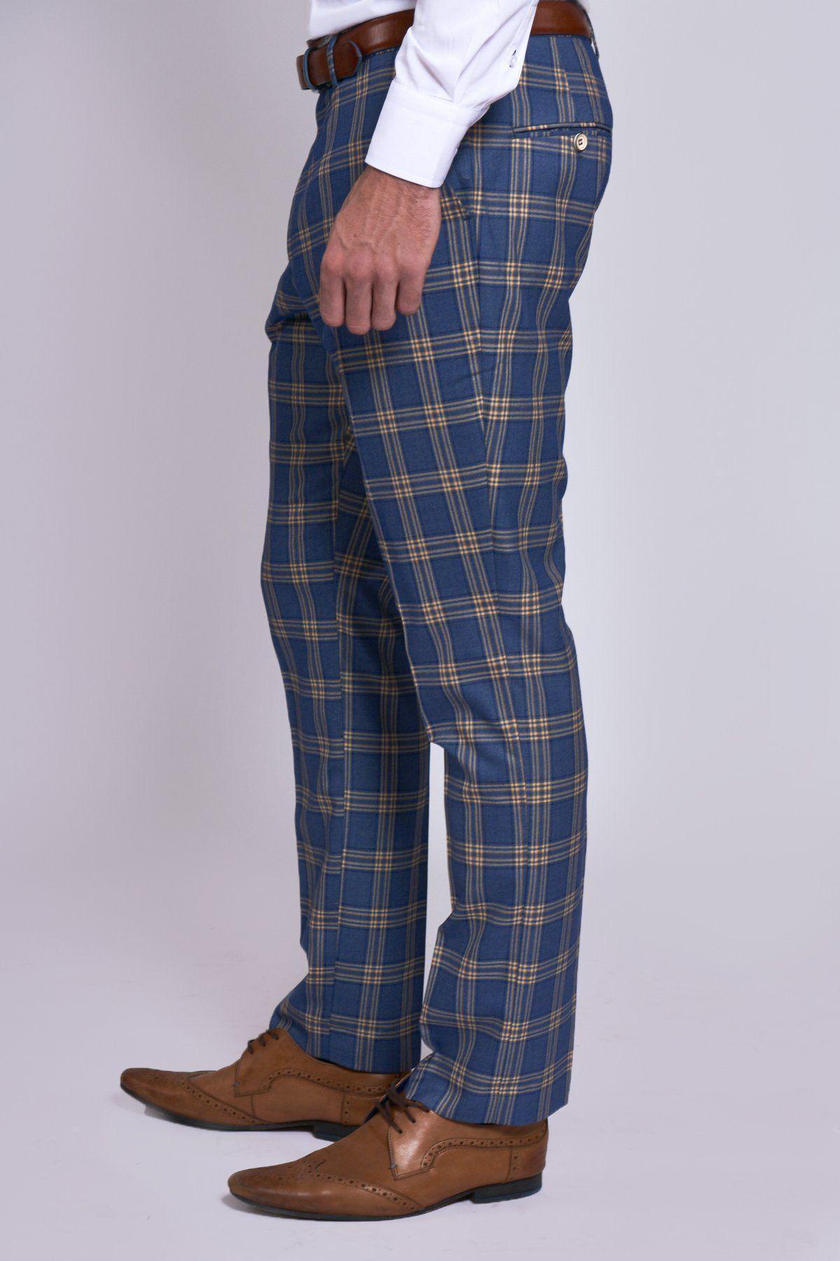 Only the lower half of a person is visible, wearing the marcdarcy TONY Blue Yellow Check Suit with Single Breasted Waistcoat, a white shirt, brown belt, and brown dress shoes against a plain light background.