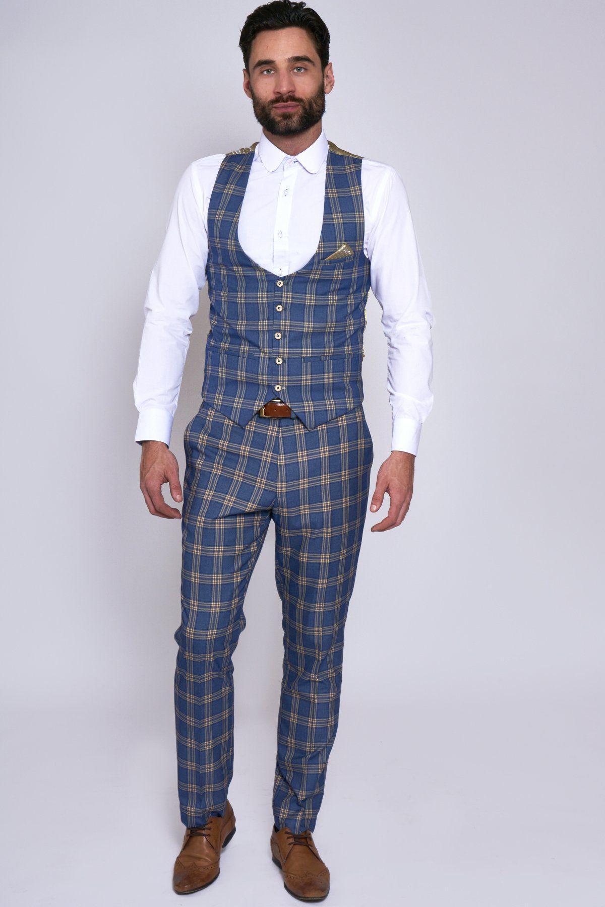 A man wears the marcdarcy TONY Blue Yellow Check Suit with a single breasted waistcoat, paired with a white shirt and brown dress shoes, standing against a plain light gray background.