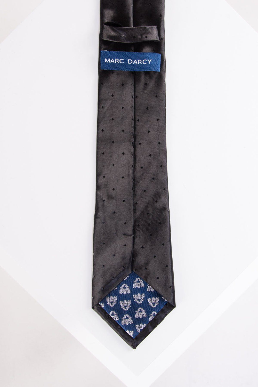TS DOT - Black Spot Print Tie and Pocket Square Set by Accessory: a black tie with small spot print and elegant detailing, ideal for formal occasions. Displayed on a white surface, this refined set adds sophistication to any outfit.