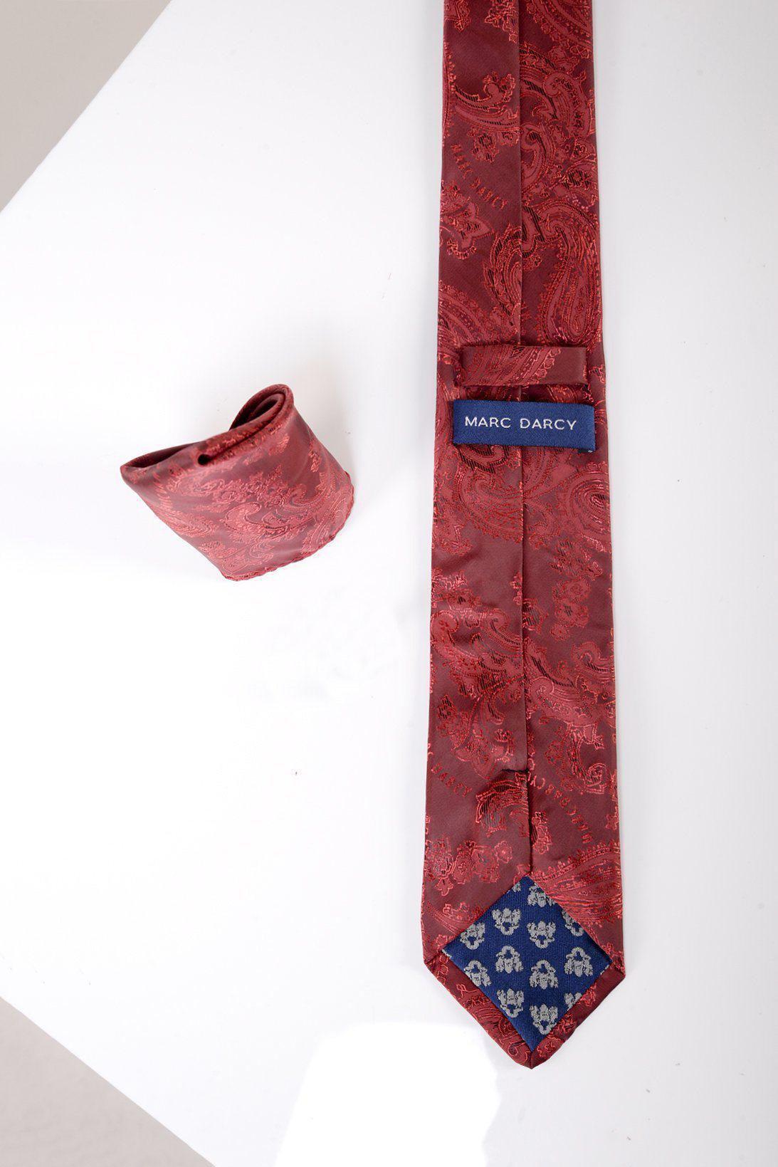 The Accessory MD PAISLEY Wine Paisley Tie and Pocket Square Set features a red paisley print tie with a blue floral tip, Marc Darcy label, and matching pocket square, styled on a white surface.