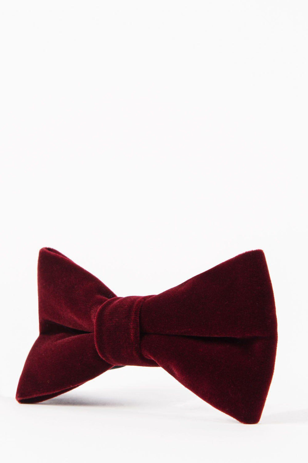 The Accessory VELVET - Wine Velvet Bow Tie, pre-tied for easy wear, sits against a white background—ideal for adding refined style to any formal occasion.